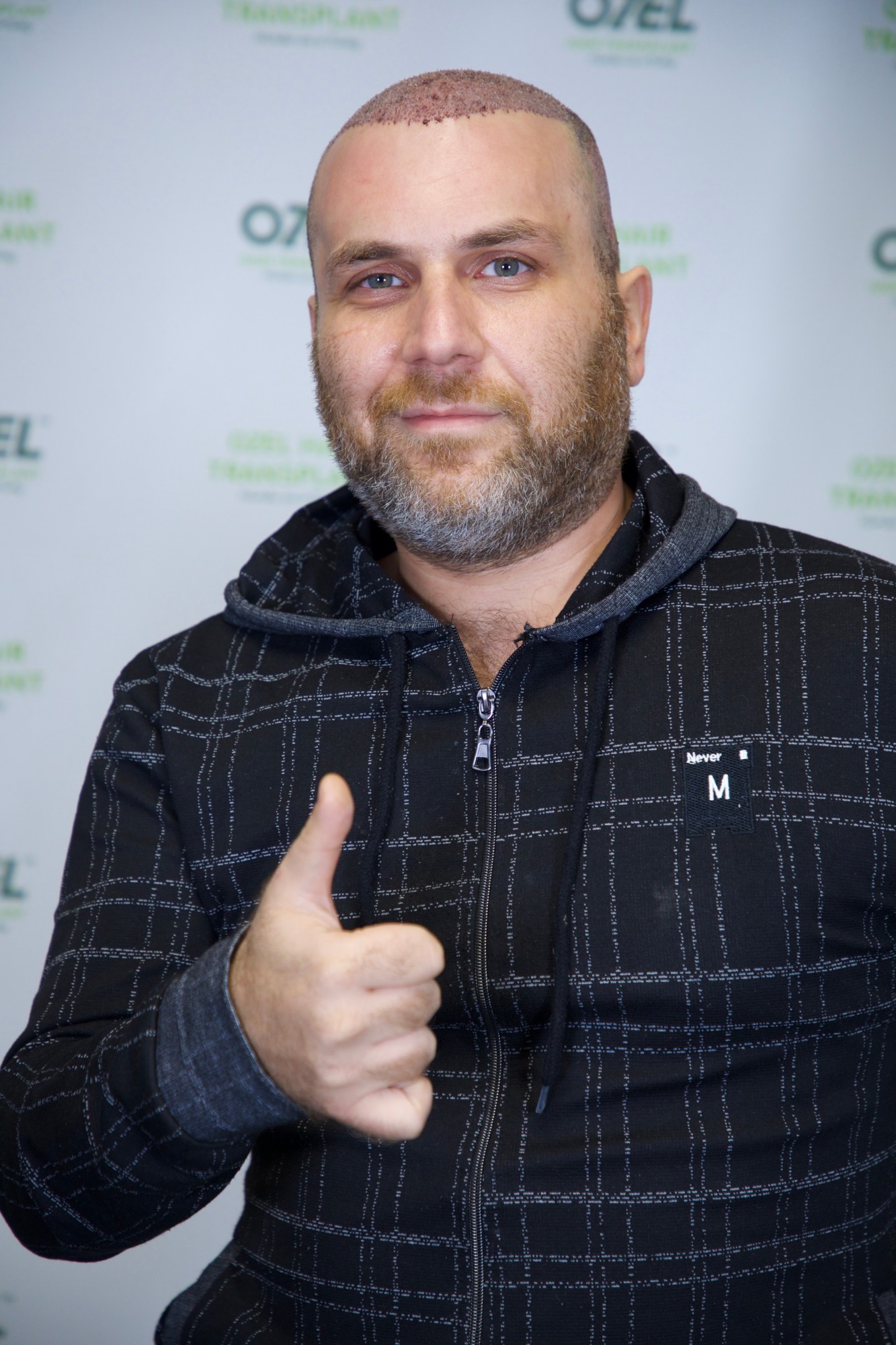 An OZEL client giving a thumbs up after his transplant